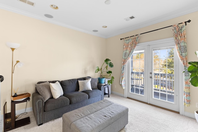 carpeted living room featuring ornamental molding and french doors