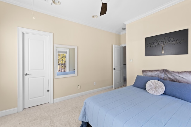 carpeted bedroom with ornamental molding and ceiling fan