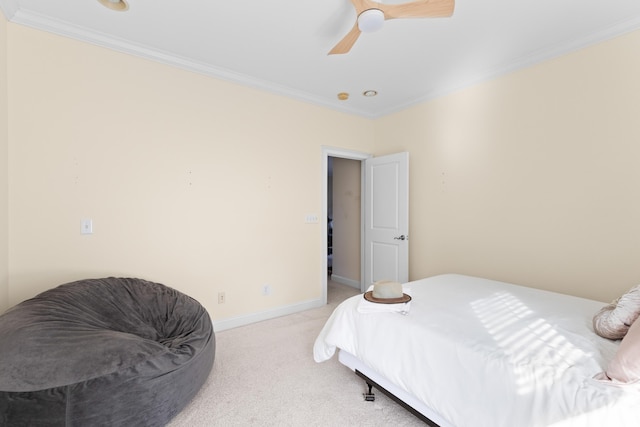 carpeted bedroom with ornamental molding and ceiling fan