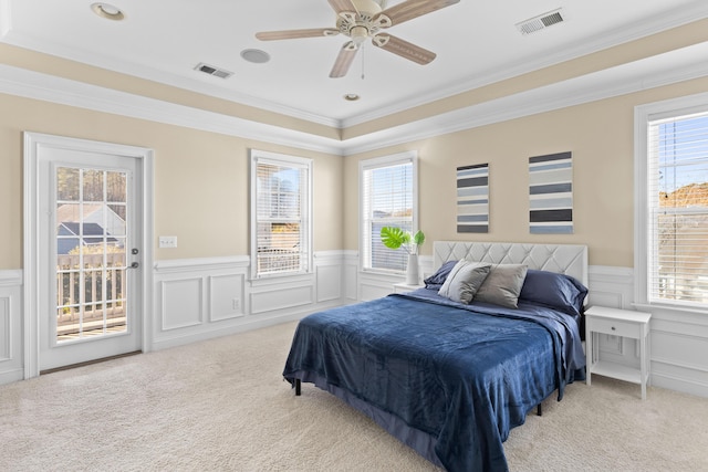 carpeted bedroom featuring ornamental molding, access to exterior, and multiple windows