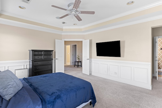 carpeted bedroom with ornamental molding and ceiling fan