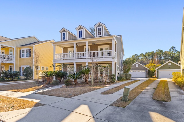 view of front of property with an outbuilding, ceiling fan, a garage, and a porch