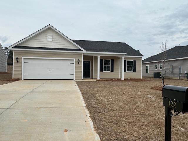 ranch-style home featuring a garage and central AC