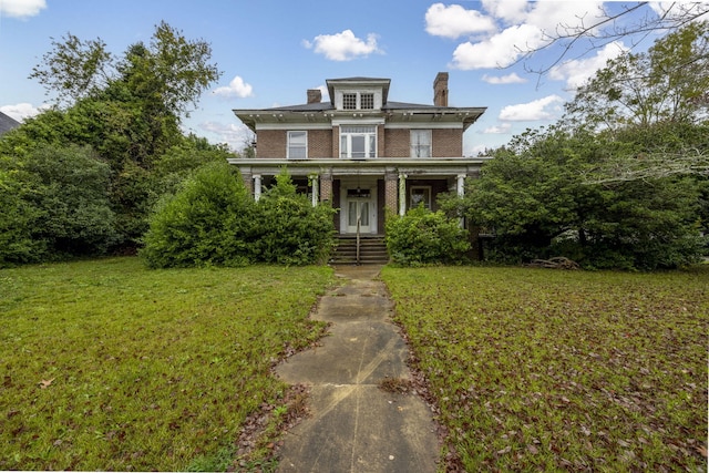 italianate-style house with a front lawn and covered porch