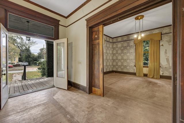 foyer entrance with crown molding and french doors