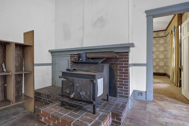 interior details featuring wood-type flooring, a wood stove, and wooden walls