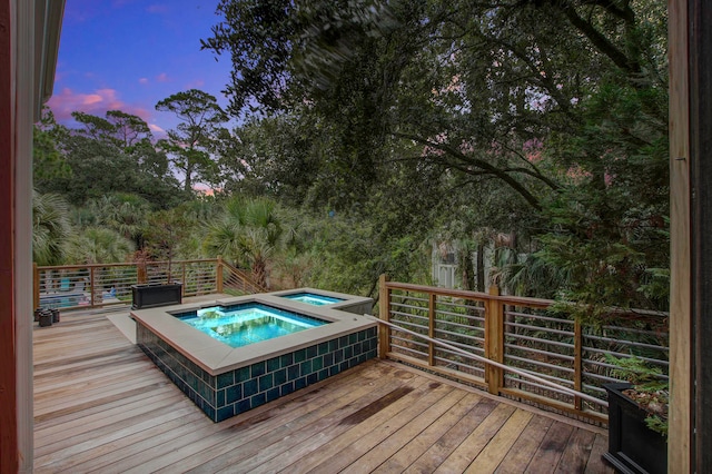 deck at dusk with an in ground hot tub