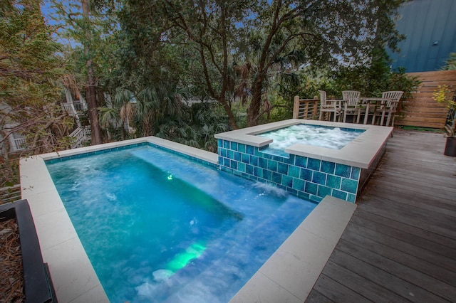 view of pool with a deck and an in ground hot tub