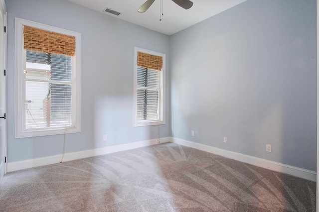 spare room featuring ceiling fan, plenty of natural light, and carpet flooring