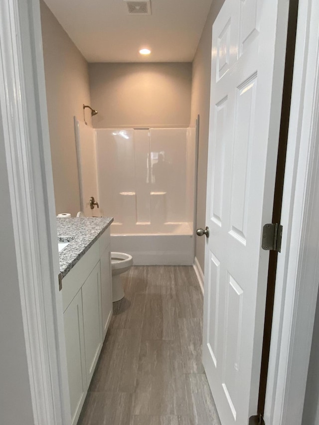 110A Dukes St, Saint George, SC 29477 - full bath with toilet, vanity, bathing tub / shower combination, wood finished floors, and recessed lighting