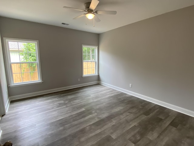 110A Dukes St, Saint George, SC 29477 - empty room with baseboards, dark wood-type flooring, and ceiling fan