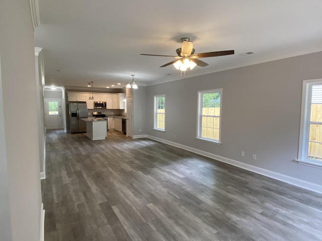 110A Dukes St, Saint George, SC 29477 - unfurnished living room with crown molding, ceiling fan, baseboards, and dark wood-style floors