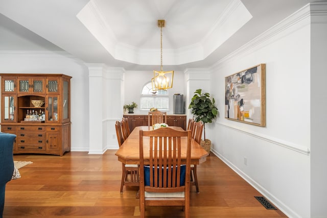 1977 Pierce St, Charleston, SC 29492 - dining room with ornamental molding, a chandelier, light wood-style flooring, visible vents, and a tray ceiling