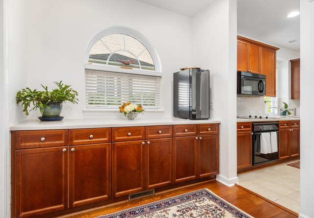 1977 Pierce St, Charleston, SC 29492 - kitchen featuring visible vents, a wealth of natural light, black appliances, and light countertops