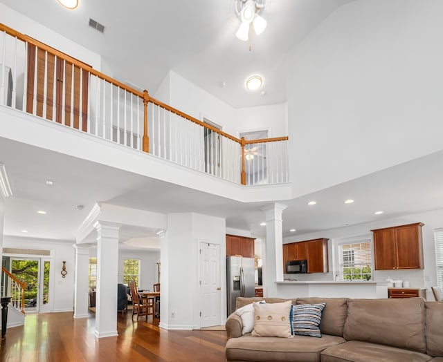 1977 Pierce St, Charleston, SC 29492 - living room with ornate columns, dark wood-style flooring, a towering ceiling, and visible vents