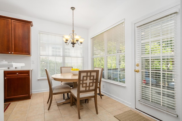 1977 Pierce St, Charleston, SC 29492 - dining room featuring light tile patterned flooring, an inviting chandelier, and baseboards