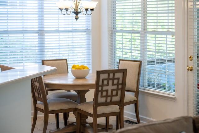 1977 Pierce St, Charleston, SC 29492 - dining room with tile patterned flooring, baseboards, and a notable chandelier
