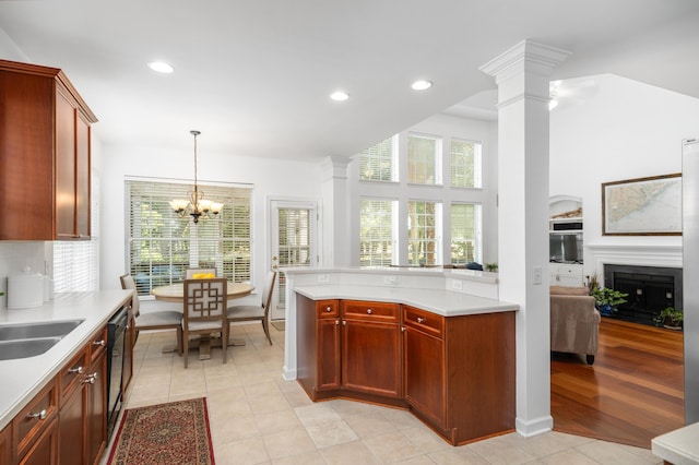 1977 Pierce St, Charleston, SC 29492 - kitchen with an inviting chandelier, a fireplace, light countertops, decorative light fixtures, and decorative columns