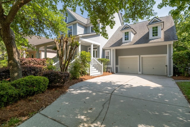 1977 Pierce St, Charleston, SC 29492 - view of front of house featuring concrete driveway, a porch, a garage, and a shingled roof