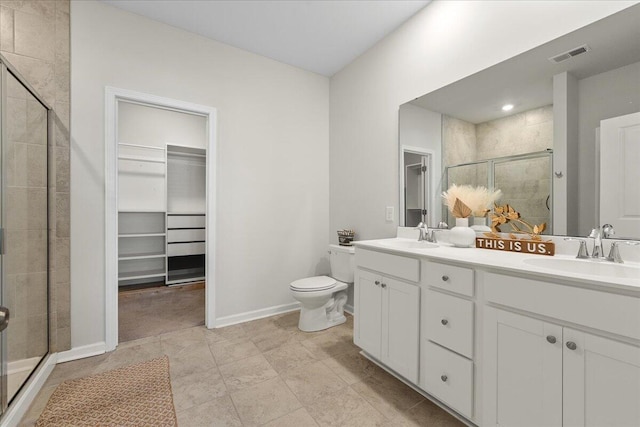 bathroom with vanity, a shower with shower door, toilet, and tile patterned flooring