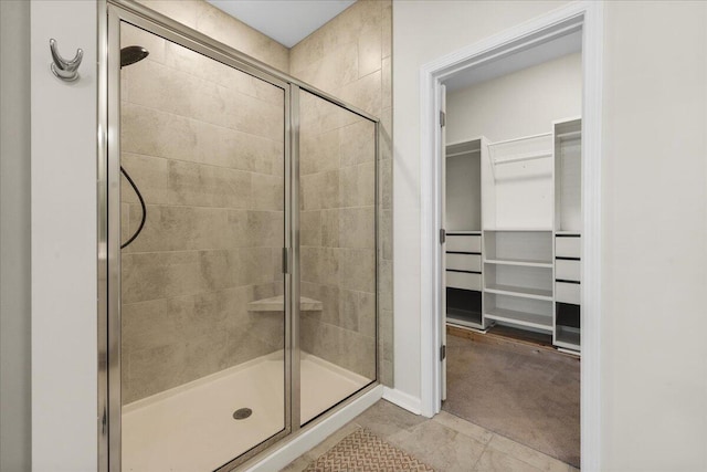 bathroom featuring tile patterned flooring and an enclosed shower