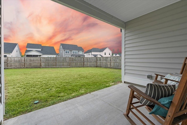 yard at dusk featuring a patio