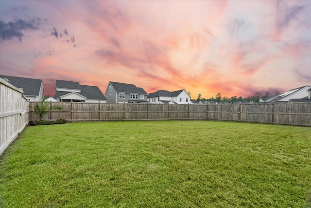 view of yard at dusk