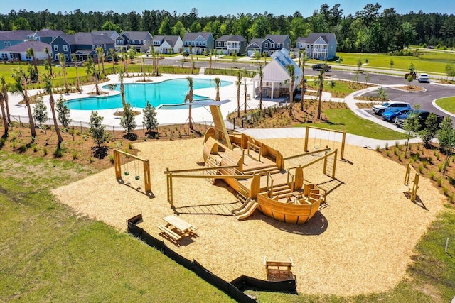 view of pool featuring a patio and a yard