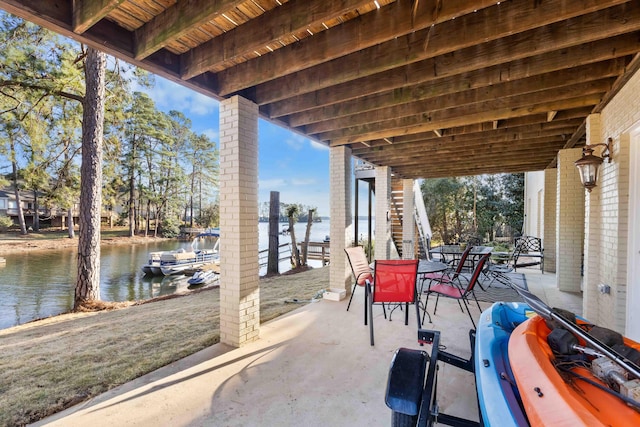 view of patio with a water view