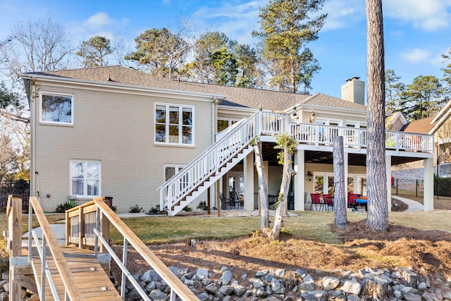 back of house with a yard, a patio, and a wooden deck