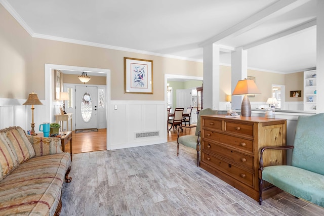 living room featuring light hardwood / wood-style floors and crown molding