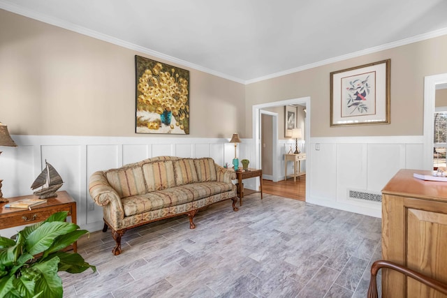 living area featuring light wood-type flooring and crown molding