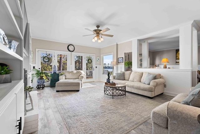 living room featuring crown molding, ceiling fan, french doors, and wood-type flooring