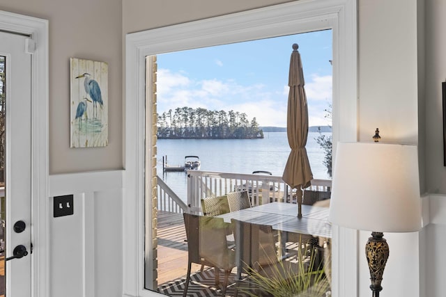 doorway with a water view and a wealth of natural light