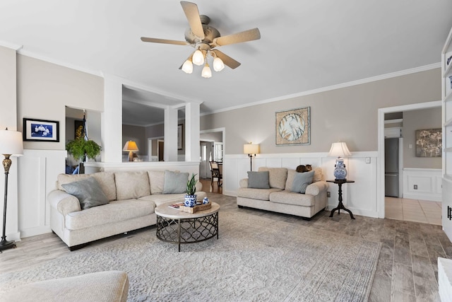 living room with ceiling fan, hardwood / wood-style floors, and ornamental molding