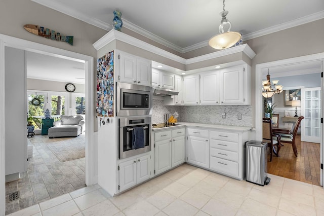 kitchen featuring backsplash, french doors, white cabinets, and appliances with stainless steel finishes