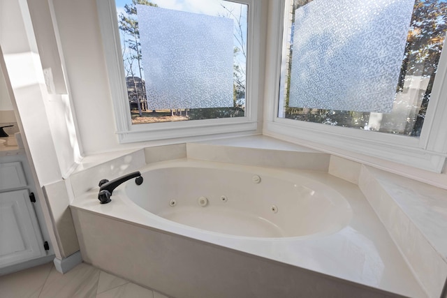 bathroom with a tub to relax in and vanity