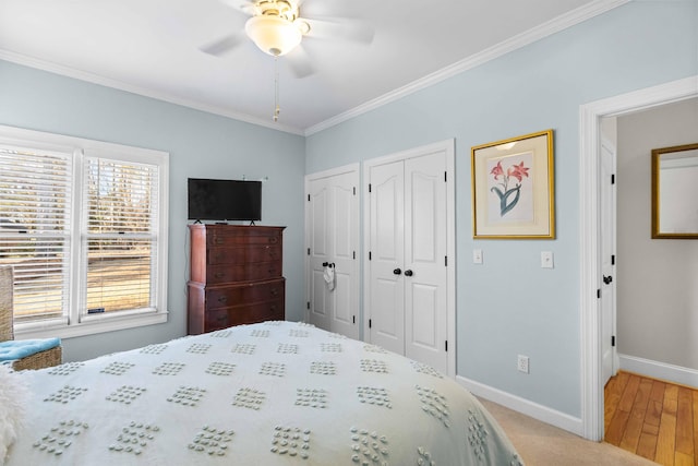 carpeted bedroom featuring ceiling fan and ornamental molding