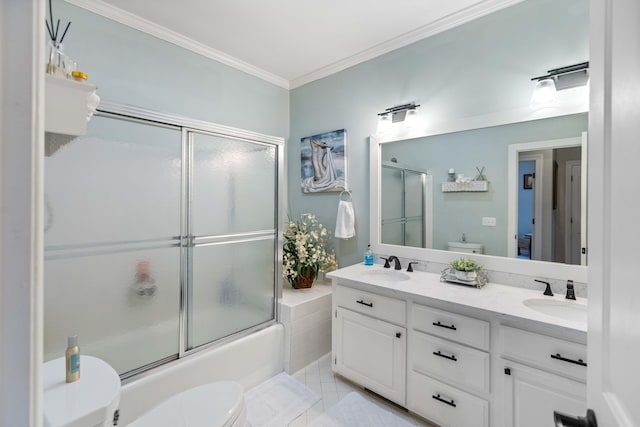 full bathroom featuring tile patterned floors, ornamental molding, vanity, shower / bath combination with glass door, and toilet