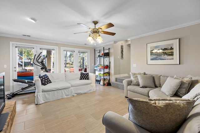 living room featuring ceiling fan and ornamental molding