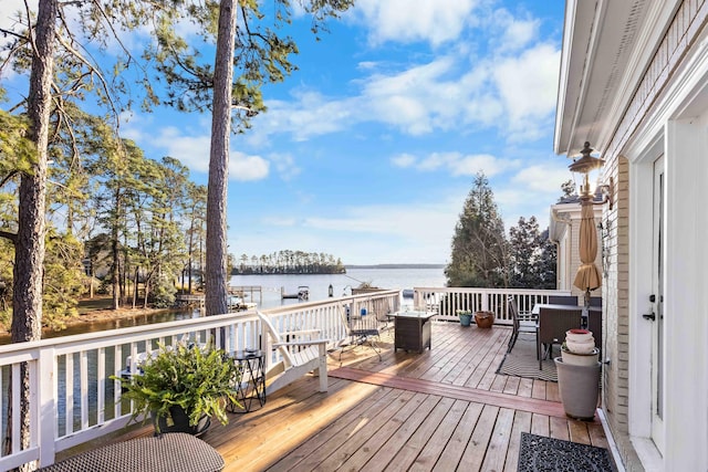 wooden terrace featuring a water view