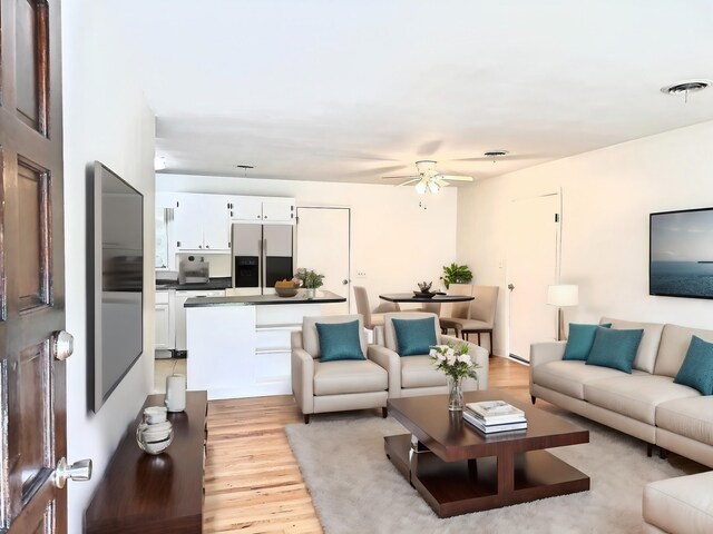 kitchen with hardwood / wood-style flooring, a textured ceiling, dishwasher, and ceiling fan