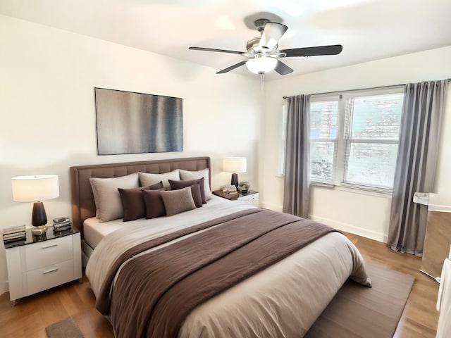 bedroom with light hardwood / wood-style flooring and ceiling fan