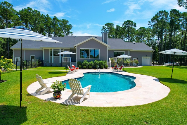 outdoor pool with a patio, a lawn, and fence