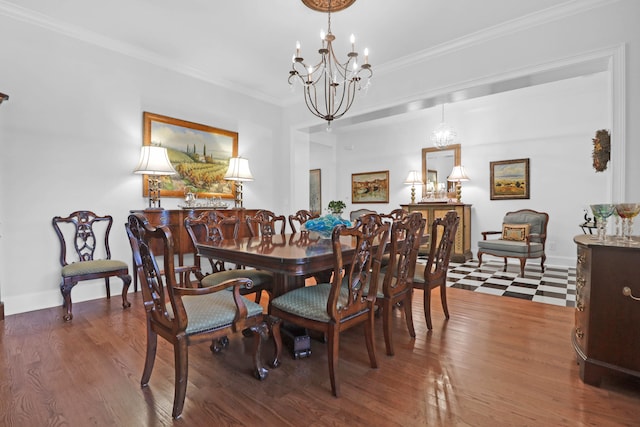 dining area featuring hardwood / wood-style flooring, ornamental molding, and a notable chandelier