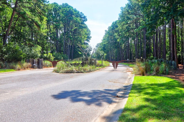 view of street featuring curbs and a gate