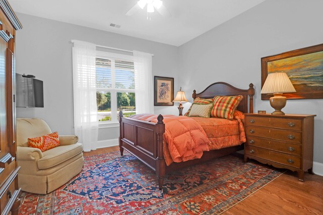 bedroom featuring dark hardwood / wood-style floors and ceiling fan