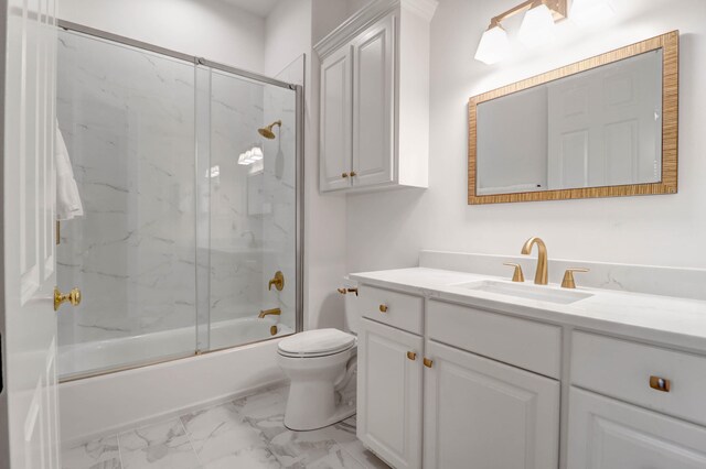 full bathroom with enclosed tub / shower combo, vanity, and toilet