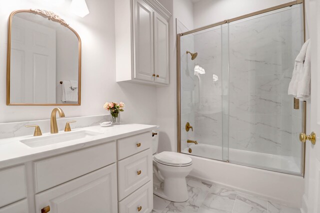 full bathroom with bath / shower combo with glass door, vanity, and toilet