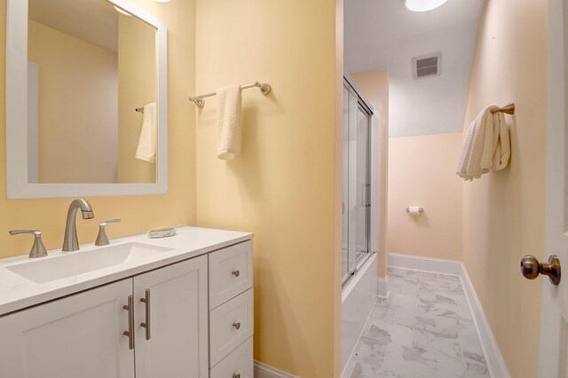 bathroom featuring vanity and combined bath / shower with glass door